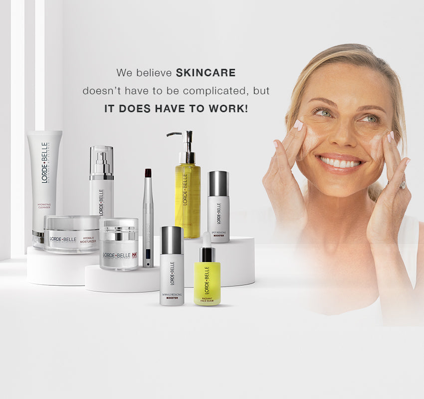 A woman smiles while applies Lorde + Belle skincare product