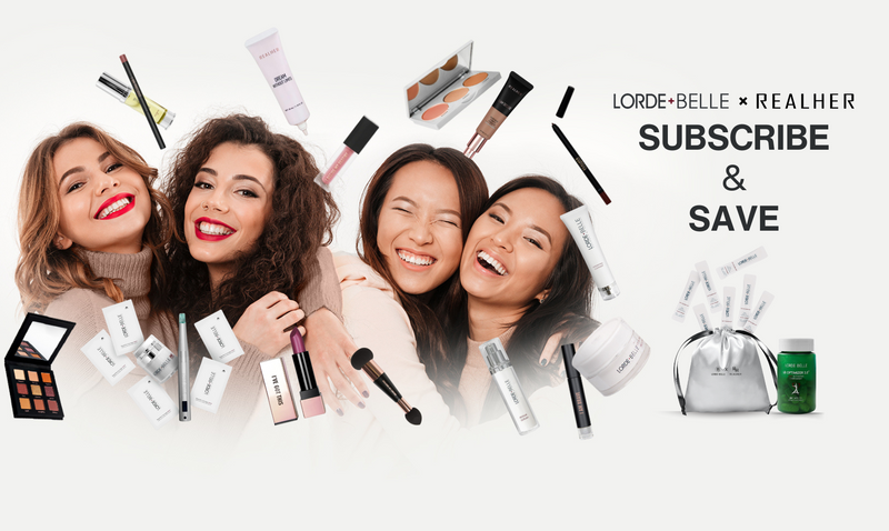 Four women smiling while holding makeup products from Lorde + Belle * Realher, promoting a subscription and savings offer